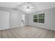 Spacious main bedroom featuring tile floors, a ceiling fan, and a window to the backyard at 10073 Dorothy Ct, Jonesboro, GA 30236