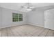 Main bedroom features a ceiling fan, tile floors, and double doors to the bathroom at 10073 Dorothy Ct, Jonesboro, GA 30236