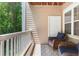 Relaxing balcony with wicker chairs and tree views offers a peaceful outdoor space at 2400 Cumberland Se Pkwy # 613, Atlanta, GA 30339