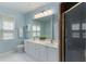 Bright bathroom featuring a dual sink vanity and shower with clear glass doors at 2400 Cumberland Se Pkwy # 613, Atlanta, GA 30339