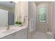 Bright bathroom featuring a single sink vanity and white cabinets with brushed nickel hardware at 2400 Cumberland Se Pkwy # 613, Atlanta, GA 30339