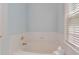Cozy bathtub with tile surround, perfect for relaxing and unwinding after a long day at 2400 Cumberland Se Pkwy # 613, Atlanta, GA 30339