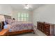 Bright bedroom featuring a ceiling fan, a window with blinds, and comfortable furnishings at 2400 Cumberland Se Pkwy # 613, Atlanta, GA 30339
