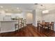 Open dining area with hardwood floors, pendant lighting, and a breakfast bar with seating at 2400 Cumberland Se Pkwy # 613, Atlanta, GA 30339