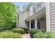 Exterior of building with lush landscaping, covered porch, and decorative columns at the entryway at 2400 Cumberland Se Pkwy # 613, Atlanta, GA 30339
