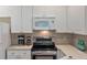 Functional kitchen with white cabinets, stainless steel appliances, and neutral countertops at 2400 Cumberland Se Pkwy # 613, Atlanta, GA 30339