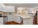 Well-lit kitchen with white cabinets, stainless steel appliances, and a view into the living room at 2400 Cumberland Se Pkwy # 613, Atlanta, GA 30339