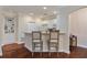 Functional kitchen with white cabinets, stainless appliances, bar seating, and hardwood floors at 2400 Cumberland Se Pkwy # 613, Atlanta, GA 30339
