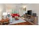 Comfortable living room featuring a fireplace, hardwood floors, neutral paint and plantation shutters at 2400 Cumberland Se Pkwy # 613, Atlanta, GA 30339