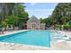 Community pool featuring lounge chairs, umbrellas, and a nearby building at 2400 Cumberland Se Pkwy # 613, Atlanta, GA 30339