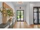Bright foyer featuring a glass front door, hardwood floors, console table, and decorative mirror at 2756 Octavia Ln, Marietta, GA 30062