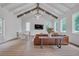 Open living room with a beamed ceiling, hardwood floors, and large windows offering abundant natural light at 2756 Octavia Ln, Marietta, GA 30062