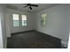 This bright bedroom is equipped with wood floors, two windows and a ceiling fan at 4 Ivy St, Porterdale, GA 30014