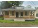 Charming home featuring a covered front porch and a well-maintained lawn at 4 Ivy St, Porterdale, GA 30014