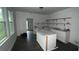 Partially renovated kitchen featuring stone countertops, island, and access to the backyard at 4 Ivy St, Porterdale, GA 30014