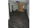 Open living area with stylish wood-look floors and natural light from multiple windows at 4 Ivy St, Porterdale, GA 30014