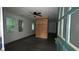 Bright living room featuring wood-look floors, large windows, and a modern ceiling fan at 4 Ivy St, Porterdale, GA 30014