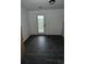 A room with dark floors and a door to the backyard at 4 Ivy St, Porterdale, GA 30014