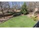 Lush backyard with mature trees and manicured lawn, creating a serene outdoor space at 5352 Lacosta Ln, Alpharetta, GA 30022