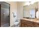 Bright bathroom features a glass shower, granite countertop and modern fixtures at 5352 Lacosta Ln, Alpharetta, GA 30022