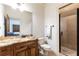 Stylish bathroom with granite vanity, a glass-enclosed shower, and access to the adjacent bedroom at 5352 Lacosta Ln, Alpharetta, GA 30022