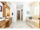 Elegant ensuite bathroom featuring a soaking tub, glass shower, and double vanity sinks at 5352 Lacosta Ln, Alpharetta, GA 30022