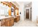 Elegant bathroom featuring dual vanities, marble countertops, and a walk-in shower with beautiful tile floors at 5352 Lacosta Ln, Alpharetta, GA 30022