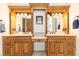 Elegant ensuite bathroom featuring double vanities with custom wood cabinetry and framed mirrors at 5352 Lacosta Ln, Alpharetta, GA 30022