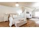 Serene bedroom with hardwood floors, a comfortable seating area, and a unique 'ATL' decor accent at 5352 Lacosta Ln, Alpharetta, GA 30022