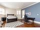 This bedroom features a work-from-home space, a walkout balcony, and hardwood floors at 5352 Lacosta Ln, Alpharetta, GA 30022