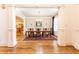 Elegant dining room with hardwood floors, wainscoting, chandelier, and large window at 5352 Lacosta Ln, Alpharetta, GA 30022