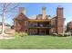 Spacious backyard with a brick home featuring a large patio and upper-level balcony at 5352 Lacosta Ln, Alpharetta, GA 30022