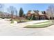 Charming home with well-maintained landscaping, a circular driveway, and a three-car garage at 5352 Lacosta Ln, Alpharetta, GA 30022