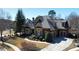 Beautifully landscaped home with mature trees, lush greenery, and a circular driveway at 5352 Lacosta Ln, Alpharetta, GA 30022