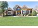 Charming two-story home with brick and stone accents, manicured lawn, and mature trees at 5352 Lacosta Ln, Alpharetta, GA 30022