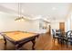 Spacious game room with pool table, hardwood floors, and dining area at 5352 Lacosta Ln, Alpharetta, GA 30022