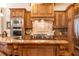 Close-up of a well-appointed kitchen with stainless steel appliances, granite counters, and custom cabinetry at 5352 Lacosta Ln, Alpharetta, GA 30022