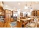 A grand kitchen, with custom cabinetry, granite countertops, and stainless steel appliances, showcases impeccable design at 5352 Lacosta Ln, Alpharetta, GA 30022