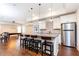 Basement kitchenette with granite counters and stainless appliances is adjacent to a game room at 5352 Lacosta Ln, Alpharetta, GA 30022