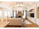 Bright and airy living room features a stone fireplace, custom built-ins, and high ceilings, creating a welcoming space at 5352 Lacosta Ln, Alpharetta, GA 30022