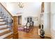 Grand entry with staircase, hardwood floors, fireplace, and beautiful chandelier, creating an inviting ambiance at 5352 Lacosta Ln, Alpharetta, GA 30022
