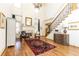Elegant living room featuring a fireplace, staircase, and hardwood floors, creating a welcoming atmosphere at 5352 Lacosta Ln, Alpharetta, GA 30022