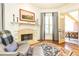 Cozy living room nook with fireplace, comfortable chair, and access to the porch at 5352 Lacosta Ln, Alpharetta, GA 30022
