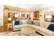 Open-concept living room flows into the kitchen with an oversized sofa and beautiful hardwood flooring at 5352 Lacosta Ln, Alpharetta, GA 30022