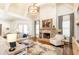 Comfortable living room with a stone fireplace, natural light, and an inviting seating area provides a cozy retreat at 5352 Lacosta Ln, Alpharetta, GA 30022