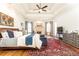 Bright main bedroom with a sitting area, tray ceilings, fireplace, and stylish decor at 5352 Lacosta Ln, Alpharetta, GA 30022