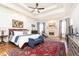 Bright main bedroom with a sitting area, tray ceilings, fireplace, and stylish decor at 5352 Lacosta Ln, Alpharetta, GA 30022