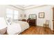 Comfortable bedroom with hardwood floors, a large dresser, and bright windows, offering a tranquil retreat at 5352 Lacosta Ln, Alpharetta, GA 30022