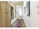 Spacious mudroom with storage and bench seating leading to an exterior entry door at 5352 Lacosta Ln, Alpharetta, GA 30022