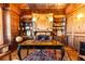 Office with wooden desk, bookshelves, fireplace, and wood paneled walls at 5352 Lacosta Ln, Alpharetta, GA 30022